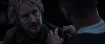 Movie still from “Secret Headquarters” (2022), directed by Henry Joost – A man is getting his teeth brushed by another man; Close Up shot, Over the shoulder angle