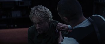 Movie still from “Secret Headquarters” (2022), directed by Henry Joost – A man getting help from another man to put a tie on him; Close Up shot, Over the shoulder angle