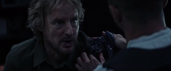 Movie still from “Secret Headquarters” (2022), directed by Henry Joost – A man holding something in his hand while another man holds something in his other hand; Close Up shot, Over the shoulder angle