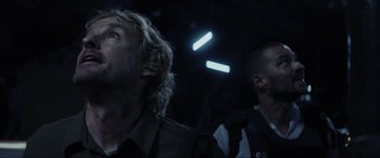 Movie still from “Secret Headquarters” (2022), directed by Henry Joost – Two men are standing in a dark room; Close Up shot, Low angle