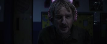 Movie still from “Secret Headquarters” (2022), directed by Henry Joost – A man with headphones is looking into the camera; Close Up shot, Over the shoulder angle