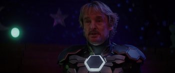 Movie still from “Secret Headquarters” (2022), directed by Henry Joost – A man wearing a suit of armor with a glowing face; Close Up shot, Over the shoulder angle