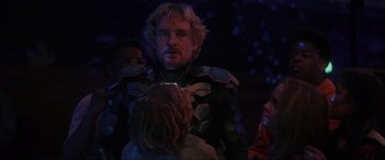 Movie still from “Secret Headquarters” (2022), directed by Henry Joost – A group of people standing in a dark room; Medium shot, Over the shoulder angle