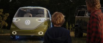 Movie still from “Secret Headquarters” (2022), directed by Henry Joost – A young boy is looking at an electric car; Wide shot, Over the shoulder angle