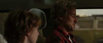 Movie still from “Secret Headquarters” (2022), directed by Henry Joost – A man and a boy sitting in the back of a car; Close Up shot, Over the shoulder angle