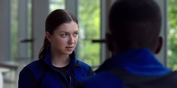 Movie still from “Secret Society of Second Born Royals” (2020), directed by Anna Mastro – A young woman talking to a man in front of a window; Close Up shot, Over the shoulder angle