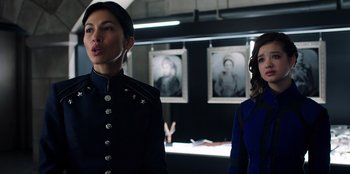 Movie still from “Secret Society of Second Born Royals” (2020), directed by Anna Mastro – Two women standing next to each other in a room; Close Up shot, Over the shoulder angle