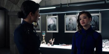 Movie still from “Secret Society of Second Born Royals” (2020), directed by Anna Mastro – A man and a woman standing next to each other in a room; Medium shot, Over the shoulder angle