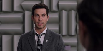 Movie still from “Secret Society of Second Born Royals” (2020), directed by Anna Mastro – A man wearing a suit and tie standing in front of a wall; Close Up shot, Over the shoulder angle