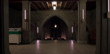 Movie still from “Secret Society of Second Born Royals” (2020), directed by Anna Mastro – An empty room in a building with lights on the ceiling; Extreme Wide shot, High angle
