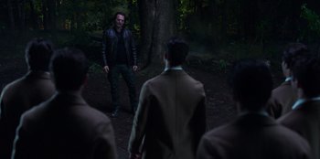 Movie still from “Secret Society of Second Born Royals” (2020), directed by Anna Mastro – A group of people standing in the woods; Wide shot, Over the shoulder angle