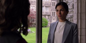 Movie still from “Secret Society of Second Born Royals” (2020), directed by Anna Mastro – A woman standing next to another woman in front of a building; Medium shot, Over the shoulder angle