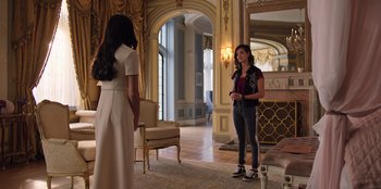 Movie still from “Secret Society of Second Born Royals” (2020), directed by Anna Mastro – Two young women in a room with a couch and a chair; Wide shot, Over the shoulder angle