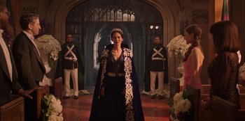 Movie still from “Secret Society of Second Born Royals” (2020), directed by Anna Mastro – A woman wearing a crown standing in front of two guards; Wide shot, Over the shoulder angle