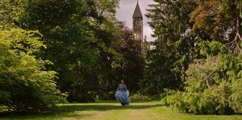 Movie still from “Secret Society of Second Born Royals” (2020), directed by Anna Mastro – A woman in a blue dress running through a park; Extreme Wide shot, Low angle