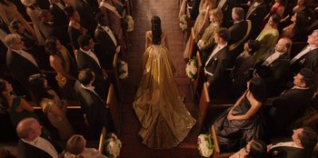 Movie still from “Secret Society of Second Born Royals” (2020), directed by Anna Mastro – A woman walking down the aisle of a church; Extreme Wide shot, High angle