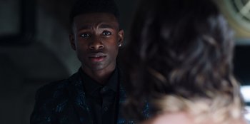 Movie still from “Secret Society of Second Born Royals” (2020), directed by Anna Mastro – A man looking into a mirror while standing next to a woman; Close Up shot, Over the shoulder angle