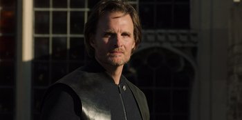 Movie still from “Secret Society of Second Born Royals” (2020), directed by Anna Mastro – A person wearing a leather vest; Close Up shot, Low angle