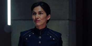 Movie still from “Secret Society of Second Born Royals” (2020), directed by Anna Mastro – A woman in a black jacket is looking to her left; Close Up shot, Over the shoulder angle