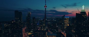 Movie still from “Section 8” (2022), directed by Christian Sesma – A view of a city at night from above; Extreme Wide shot, High angle
