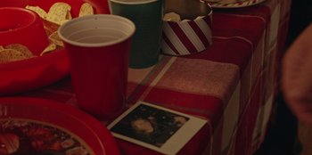 Movie still from “See You Next Christmas” (2021), directed by Christine Weatherup – Cups and cups on the table; Extreme Close Up shot, High angle
