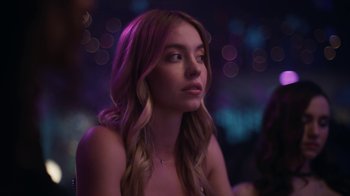 Movie still from “Euphoria” (2019), created by Sam Levinson – A woman with long hair sitting in front of a purple background; Close Up shot, Over the shoulder angle