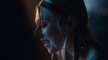 Movie still from “Euphoria” (2019), created by Sam Levinson – A young girl with long dark hair is smiling; Extreme Close Up shot, Low angle