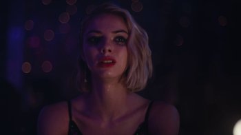 Movie still from “Euphoria” (2019), created by Sam Levinson – A woman in a black top is standing in a dark room; Close Up shot, Low angle