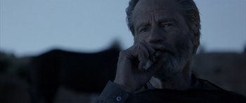 Movie still from “Blackthorn” (2011), directed by Mateo Gil – An older man talking on a cell phone; Close Up shot, Low angle