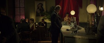 Movie still from “Blackthorn” (2011), directed by Mateo Gil – A group of people sitting at a table in a room; Wide shot, Over the shoulder angle