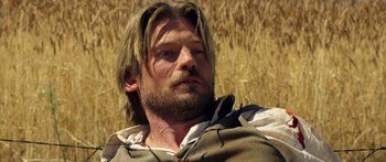 Movie still from “Blackthorn” (2011), directed by Mateo Gil – A person with long hair and a beard; Close Up shot, Over the shoulder angle