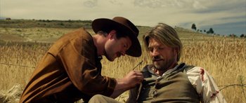 Movie still from “Blackthorn” (2011), directed by Mateo Gil – A man in a cowboy hat and a man in a suit and tie; Medium shot, Over the shoulder angle