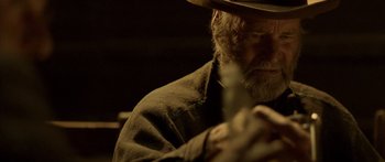Movie still from “Blackthorn” (2011), directed by Mateo Gil – An old man with a beard wearing a cowboy hat; Close Up shot, Over the shoulder angle