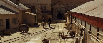 Movie still from “Blackthorn” (2011), directed by Mateo Gil – Two men on horseback riding down a train track; Extreme Wide shot, High angle