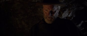 Movie still from “Blackthorn” (2011), directed by Mateo Gil – An old man with a beard wearing a black hat; Close Up shot, Over the shoulder angle