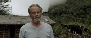 Movie still from “Blackthorn” (2011), directed by Mateo Gil – An older man standing in front of a house; Close Up shot, Low angle