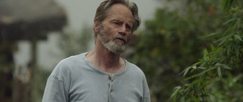 Movie still from “Blackthorn” (2011), directed by Mateo Gil – An older man with a beard is standing outside; Close Up shot, Low angle