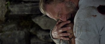 Movie still from “Blackthorn” (2011), directed by Mateo Gil – An older man with his hands over his face; Close Up shot, Overhead angle