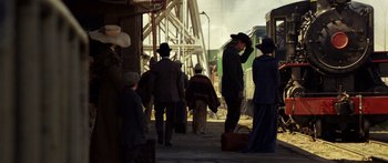 Movie still from “Blackthorn” (2011), directed by Mateo Gil – A group of people walking down a train platform; Wide shot, Over the shoulder angle