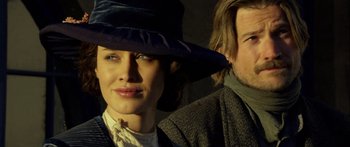 Movie still from “Blackthorn” (2011), directed by Mateo Gil – A man and a woman wearing a hat and posing for a picture; Close Up shot, Low angle