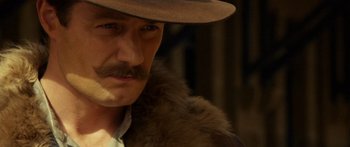 Movie still from “Blackthorn” (2011), directed by Mateo Gil – A person wearing a hat; Close Up shot, Over the shoulder angle