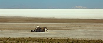 Movie still from “Blackthorn” (2011), directed by Mateo Gil – An abandoned house in the middle of a desert plain; Extreme Wide shot, High angle