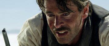 Movie still from “Blackthorn” (2011), directed by Mateo Gil – A man's face with a beard; Close Up shot, Over the shoulder angle