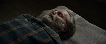 Movie still from “Blackthorn” (2011), directed by Mateo Gil – An old man with a beard is laying on a blanket; Close Up shot, High angle