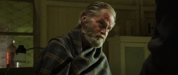 Movie still from “Blackthorn” (2011), directed by Mateo Gil – An older man with a beard and a blanket; Close Up shot, Low angle