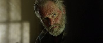 Movie still from “Blackthorn” (2011), directed by Mateo Gil – An old man with a beard and a white mustache; Close Up shot, Low angle