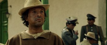 Movie still from “Blackthorn” (2011), directed by Mateo Gil – A man wearing a hat and looking at the camera; Close Up shot, Over the shoulder angle