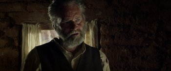 Movie still from “Blackthorn” (2011), directed by Mateo Gil – An old man with a beard and a white mustache; Close Up shot, Over the shoulder angle