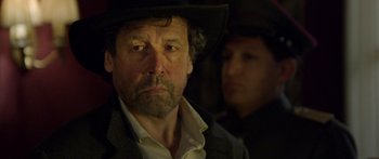 Movie still from “Blackthorn” (2011), directed by Mateo Gil – A person wearing a cowboy hat; Close Up shot, Over the shoulder angle