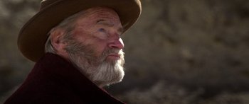 Movie still from “Blackthorn” (2011), directed by Mateo Gil – An old man with a beard wearing a brown hat; Close Up shot, Low angle